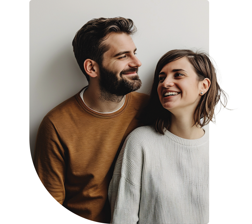 A smiling man and woman looking at each other