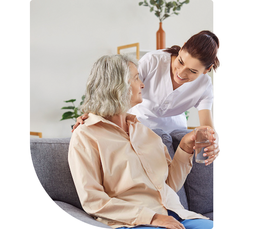 pharmacist giving an elderly woman a glass of water