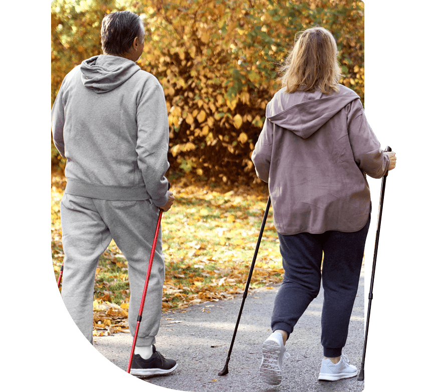 A couple pole walking through a fall scene